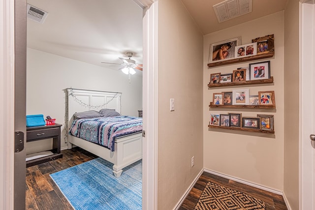 bedroom with visible vents, baseboards, and dark wood-style flooring