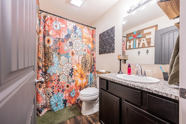 full bathroom with vanity, a shower with curtain, toilet, and wood finished floors