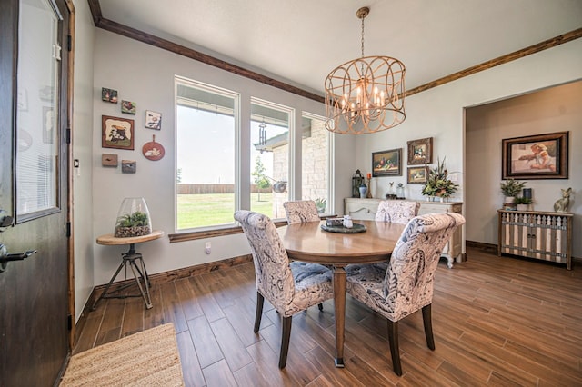 dining area with a chandelier, plenty of natural light, and crown molding