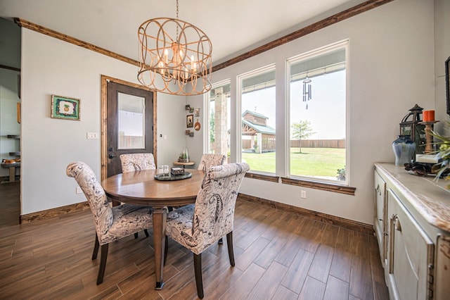 dining area featuring dark hardwood / wood-style flooring, ornamental molding, and a chandelier