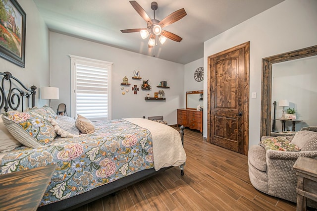 bedroom with hardwood / wood-style floors and ceiling fan