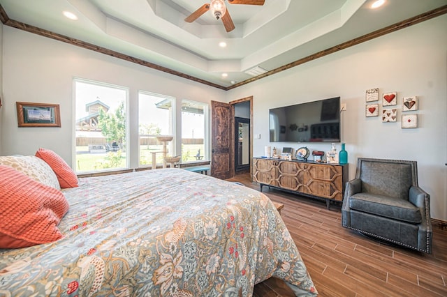 bedroom with a tray ceiling, ceiling fan, and ornamental molding