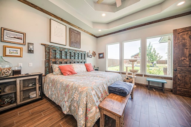 bedroom with ceiling fan, crown molding, and a tray ceiling