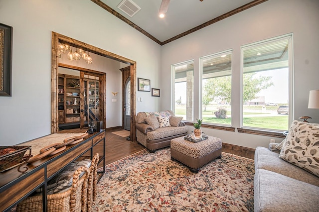 living room featuring ceiling fan, dark hardwood / wood-style flooring, and crown molding