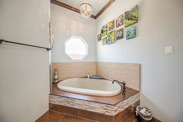 bathroom featuring tile patterned floors, a notable chandelier, and tiled tub