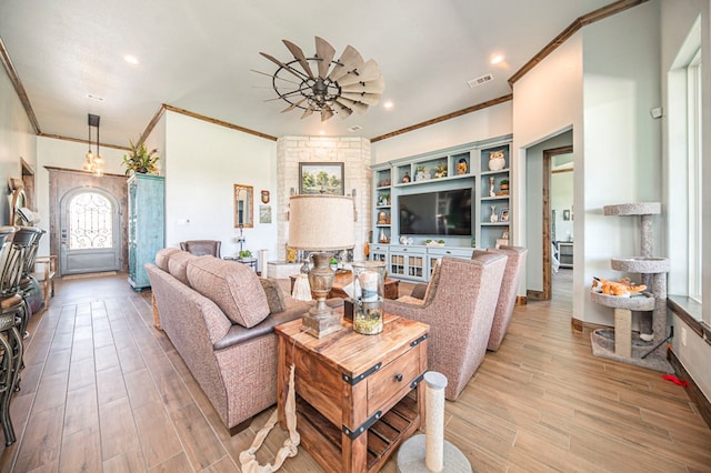 living room featuring ceiling fan and ornamental molding