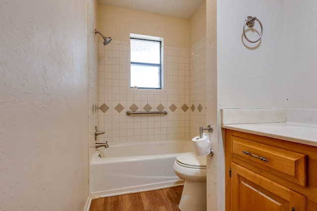 2100 Edgemere Rd, Big Spring, TX 79720 - bathroom featuring vanity, a textured wall, wood finished floors, toilet, and shower / bathing tub combination