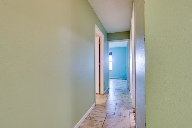 2100 Edgemere Rd, Big Spring, TX 79720 - hallway featuring baseboards and a textured wall