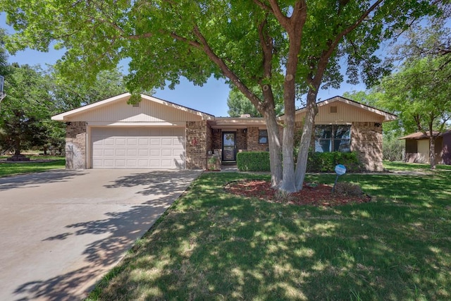 2100 Edgemere Rd, Big Spring, TX 79720 - ranch-style house with an attached garage, a front yard, driveway, and brick siding