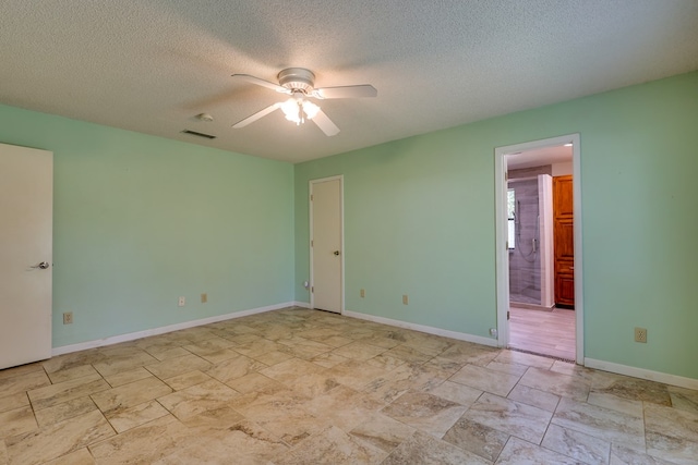 2100 Edgemere Rd, Big Spring, TX 79720 - unfurnished bedroom with connected bathroom, ceiling fan, a textured ceiling, stone finish flooring, and visible vents