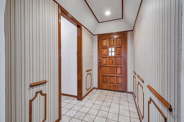 foyer with recessed lighting, light floors, and lofted ceiling