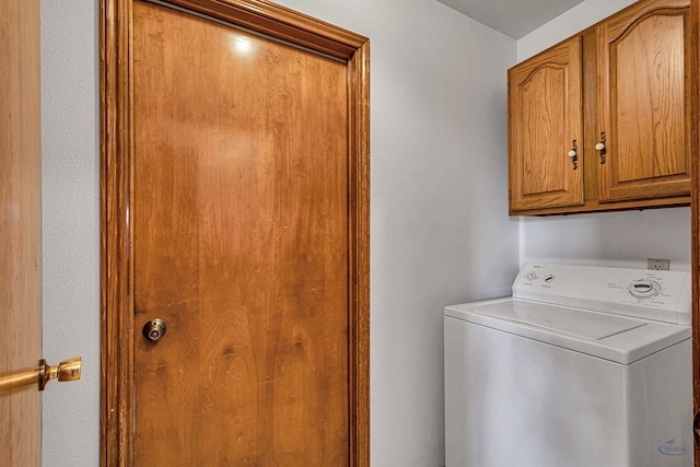 laundry area featuring cabinet space and washer / dryer