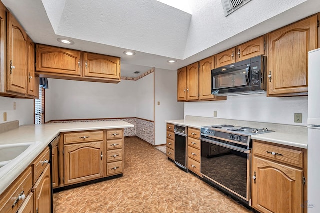 kitchen featuring a textured ceiling, electric range oven, recessed lighting, black microwave, and light countertops