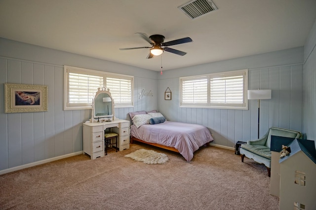 carpeted bedroom featuring baseboards and a ceiling fan