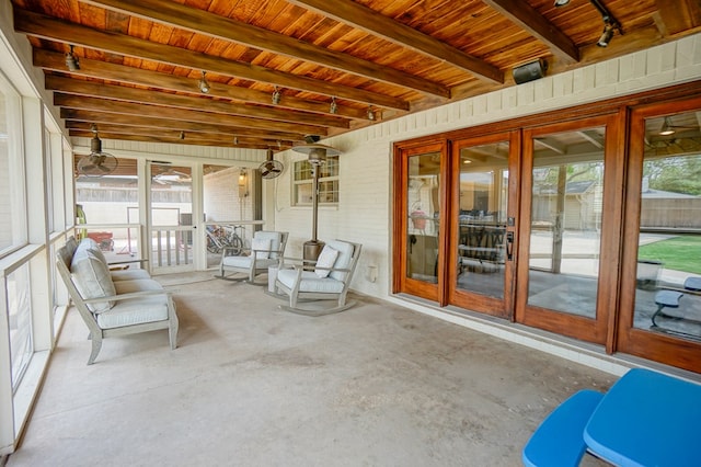 sunroom / solarium with beam ceiling, french doors, and a ceiling fan