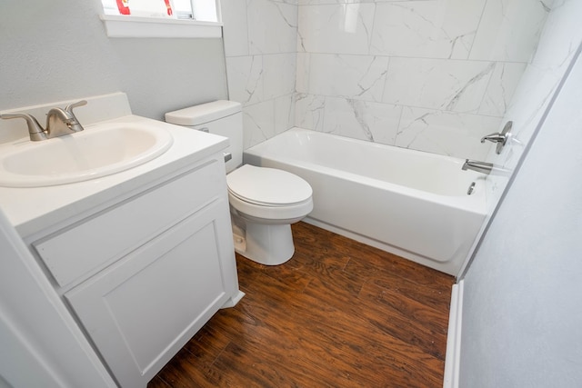 full bathroom with vanity, toilet, wood-type flooring, and tiled shower / bath combo