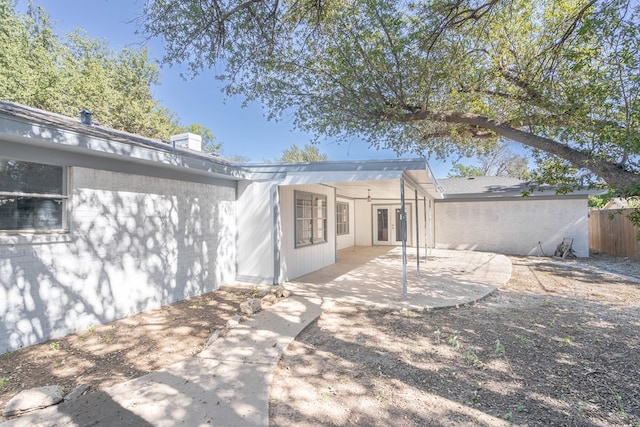 rear view of property featuring a patio area and ceiling fan