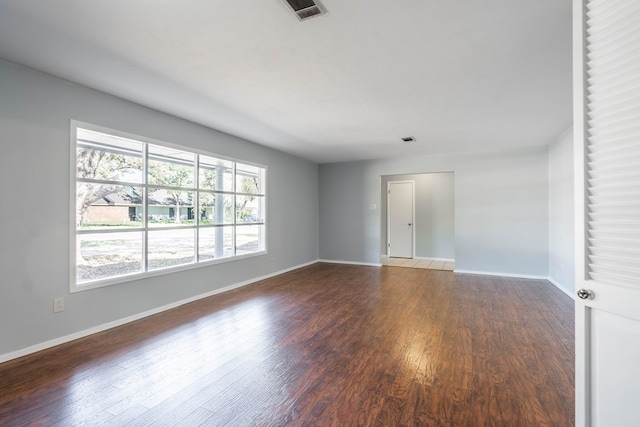 spare room featuring dark wood-type flooring