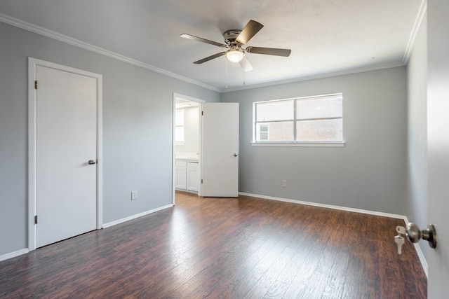 unfurnished bedroom with ornamental molding, ensuite bathroom, ceiling fan, and dark wood-type flooring