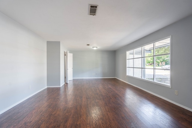 spare room featuring dark wood-type flooring