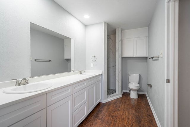 bathroom with walk in shower, vanity, wood-type flooring, and toilet