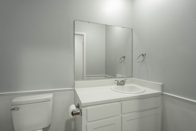 bathroom featuring vanity and toilet