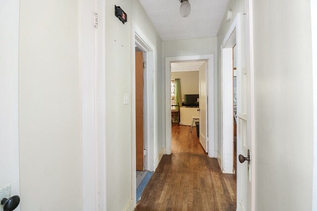 605 W Walnut St, Coleman, TX 76834 - corridor featuring dark wood-style flooring