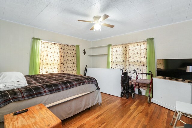 605 W Walnut St, Coleman, TX 76834 - bedroom featuring wood finished floors and ceiling fan