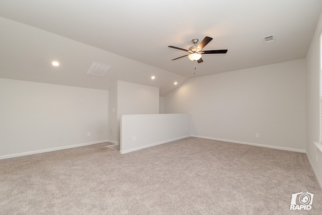interior space with visible vents, carpet, ceiling fan, and vaulted ceiling