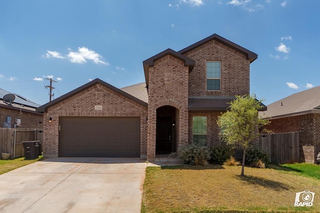 traditional home with brick siding, fence, driveway, and a garage