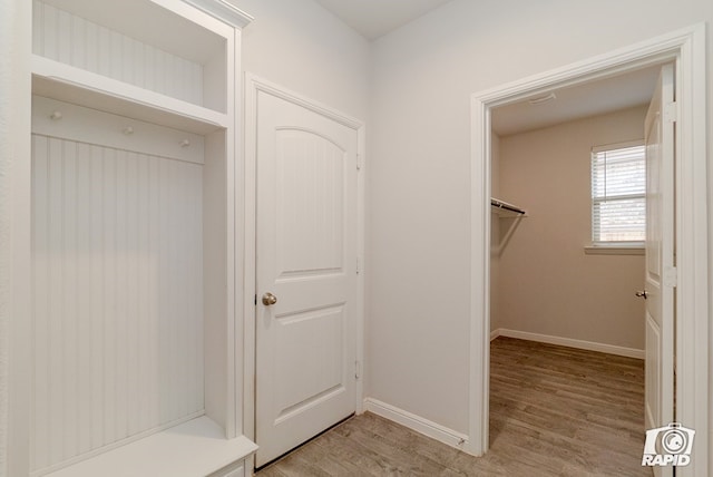 mudroom featuring baseboards and light wood-type flooring