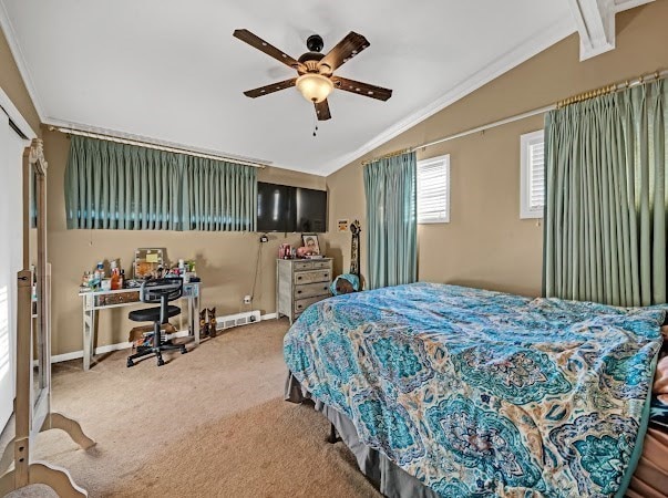 bedroom featuring vaulted ceiling with beams, ceiling fan, crown molding, and carpet