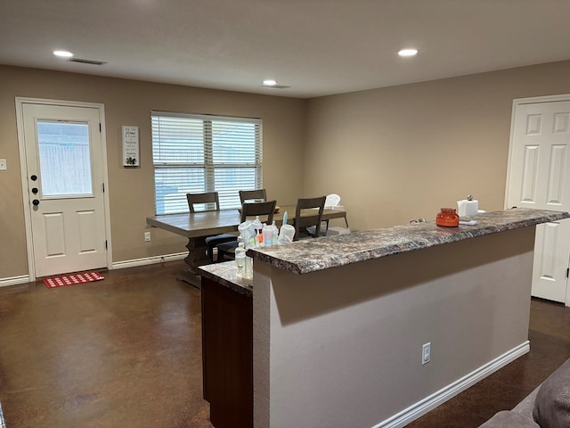 kitchen featuring light stone counters and a center island