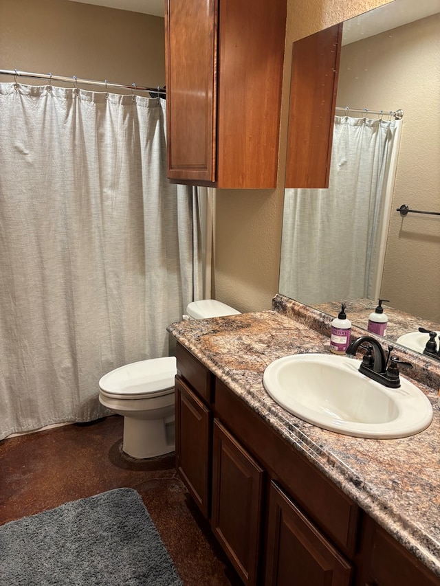 bathroom featuring vanity and toilet