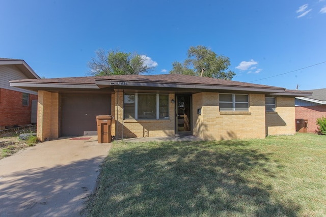 view of front of house with a garage and a front lawn