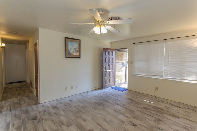 empty room with light hardwood / wood-style flooring and ceiling fan