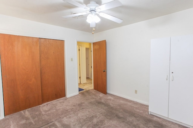 unfurnished bedroom with carpet flooring, a closet, and ceiling fan