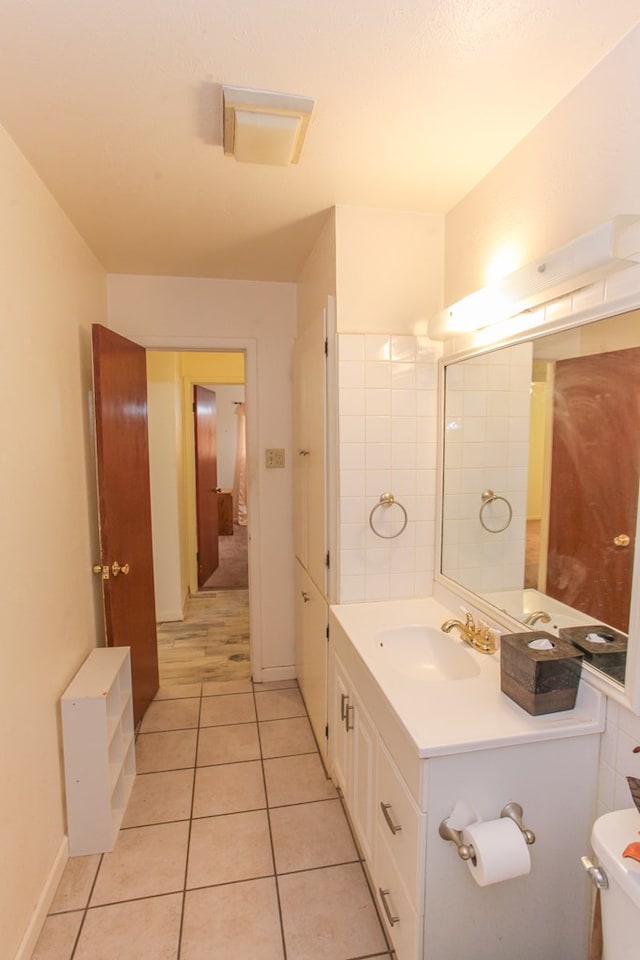 bathroom with tile patterned flooring, vanity, and toilet