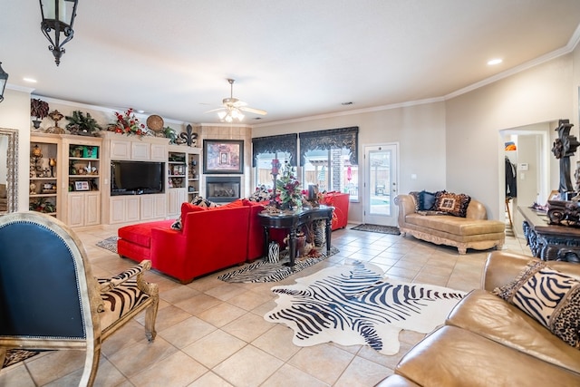 living room with light tile patterned floors, a fireplace, ornamental molding, and ceiling fan