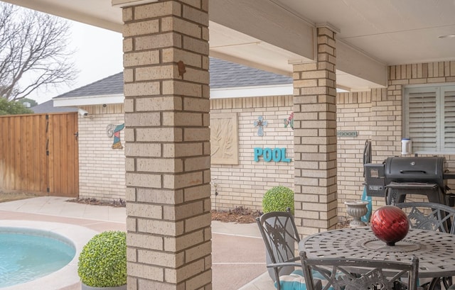 view of patio featuring a fenced in pool and area for grilling