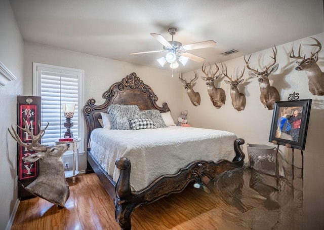 bedroom with wood-type flooring and ceiling fan