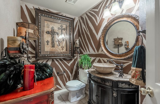 bathroom featuring vanity, tile patterned floors, and toilet