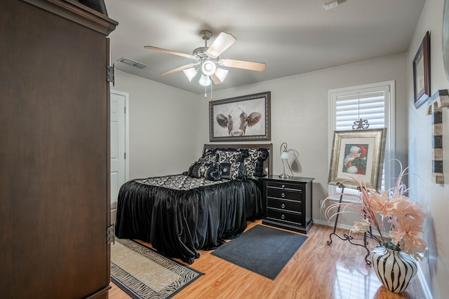 bedroom with ceiling fan and light wood-type flooring