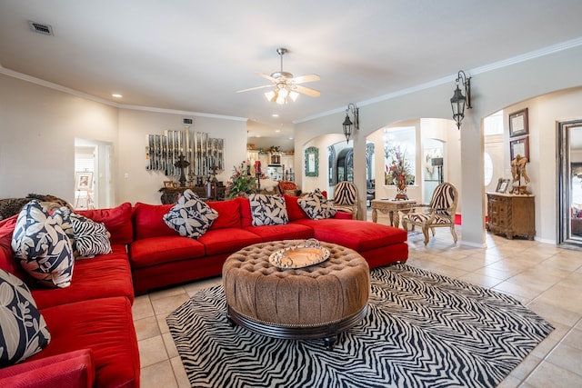 living room with light tile patterned floors, crown molding, and a healthy amount of sunlight