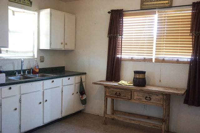 kitchen featuring white cabinets and sink