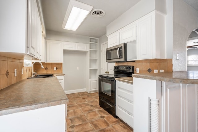 kitchen with white cabinetry, black electric range oven, sink, backsplash, and kitchen peninsula