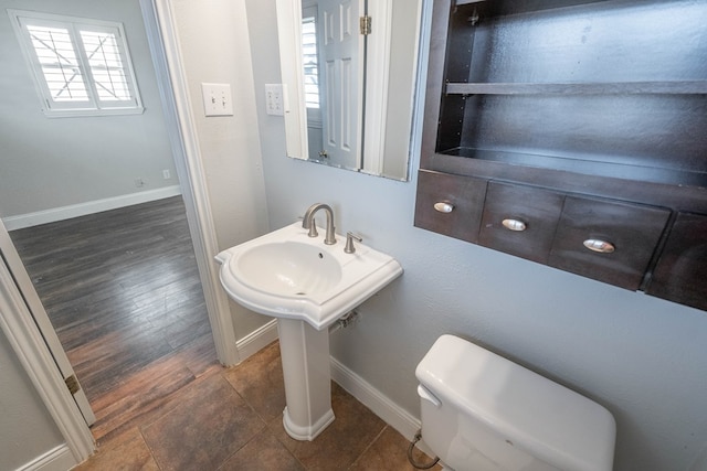 bathroom with hardwood / wood-style flooring and toilet