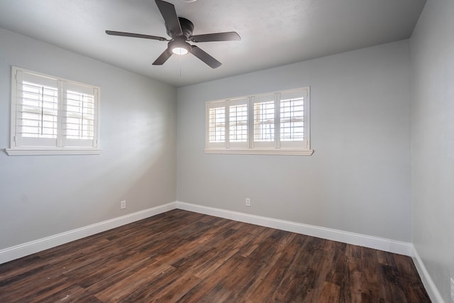 empty room with dark wood-type flooring and ceiling fan