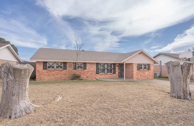 ranch-style house featuring central AC and a front yard