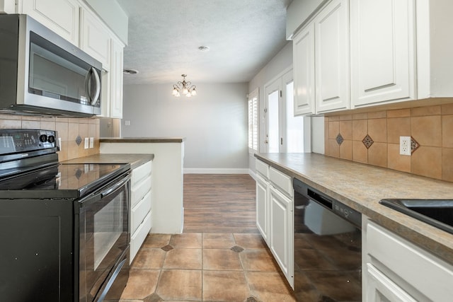 kitchen with white cabinetry, tasteful backsplash, a textured ceiling, hanging light fixtures, and black appliances